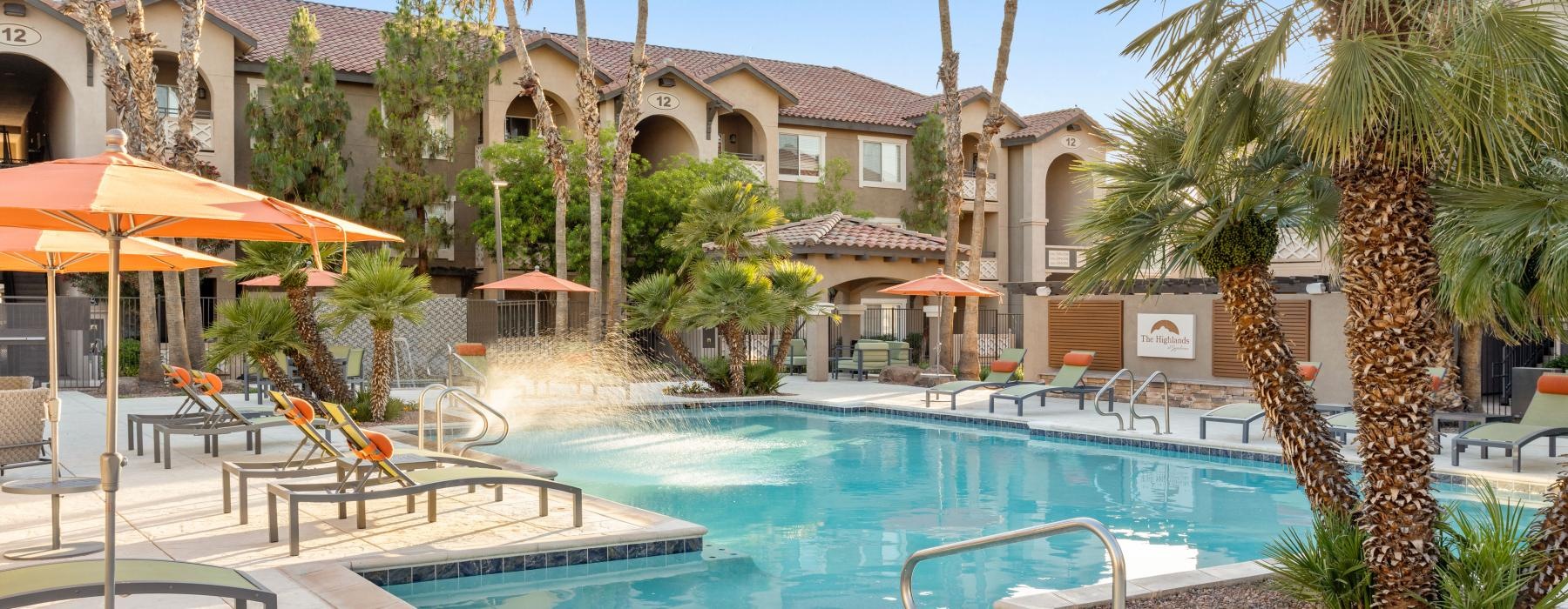 a pool with apartment building in the background