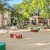 a courtyard with cornhole and picnic tables