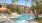 a pool with apartment building in the background