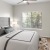 a bedroom with a bed and a fan