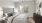 a bedroom with a bed and a fan
